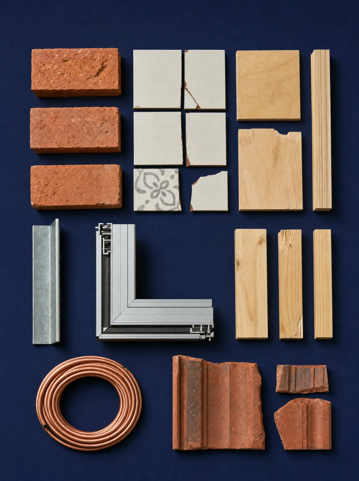 Renovation offcuts laid out in a neat grid: bricks, tiles, plywood, steel and aluminium